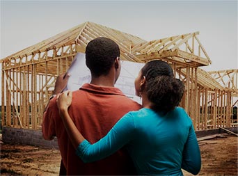 family looking at their new home construction